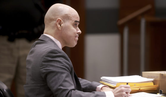 Robert Telles, a former Clark County public administrator charged in the murder of Las Vegas Review-Journal investigative journalist Jeff German, takes notes while listening to testimony during his murder trial at the Regional Justice Center in Las Vegas on Friday.