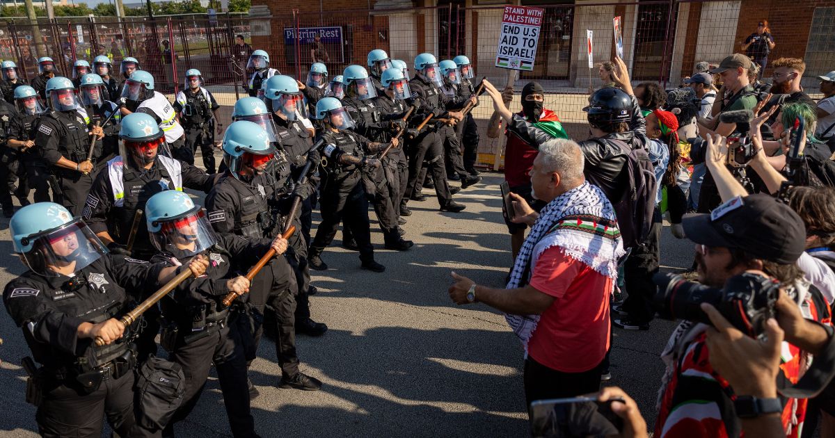 Chicago police move in on protesters who had tried to break through the perimeter near the Democratic National Convention (DNC) at the United Center on August 19, 2024 in Chicago, Illinois.