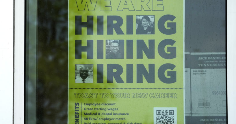 A hiring sign is displayed at a liquor store in Arlington Heights, Illinois on May 21, 2024.