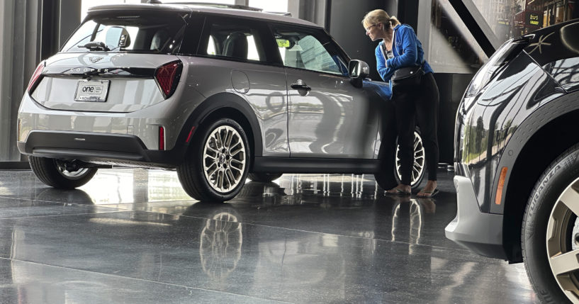 A prospective buyer examines a 2025 Cooper S hardtop on display on the showroom floor of a Mini dealership Monday, July 22, 2024, in Highlands Ranch, Colorado.