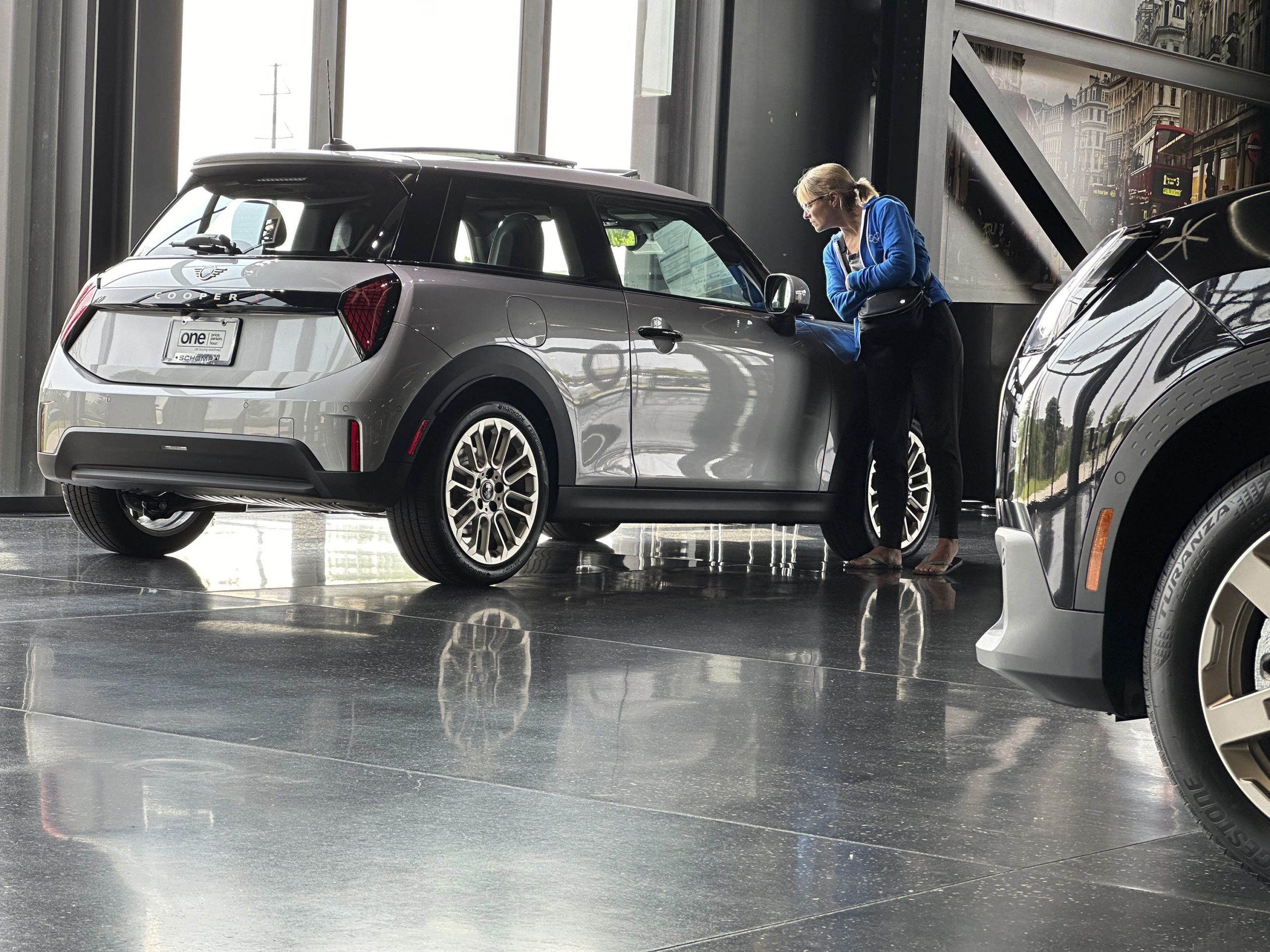 A prospective buyer examines a 2025 Cooper S hardtop on display on the showroom floor of a Mini dealership Monday, July 22, 2024, in Highlands Ranch, Colorado.