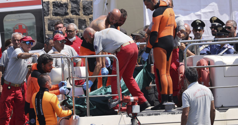 People work the scene after the fatal capsizing of a superyacht in the Mediterranean.