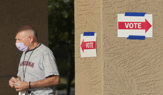 A precinct worker walks outside a voting location during the state's primary election, Tuesday, July 30, 2024, in Sun City West, Arizona.