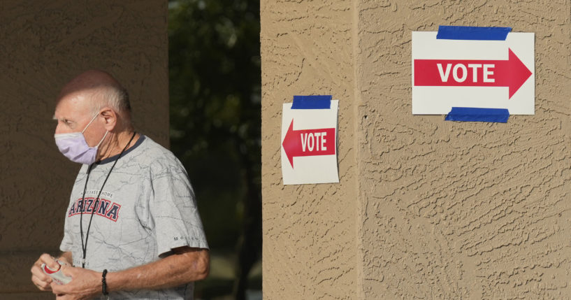 A precinct worker walks outside a voting location during the state's primary election, Tuesday, July 30, 2024, in Sun City West, Arizona.