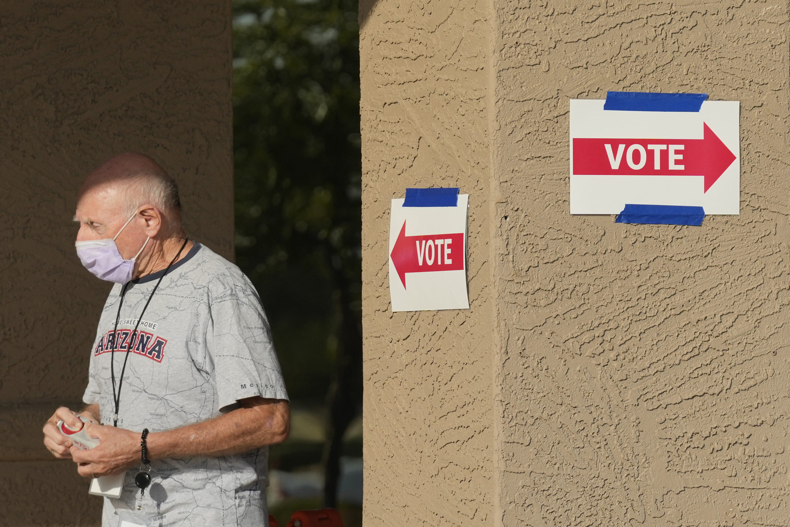 A precinct worker walks outside a voting location during the state's primary election, Tuesday, July 30, 2024, in Sun City West, Arizona.