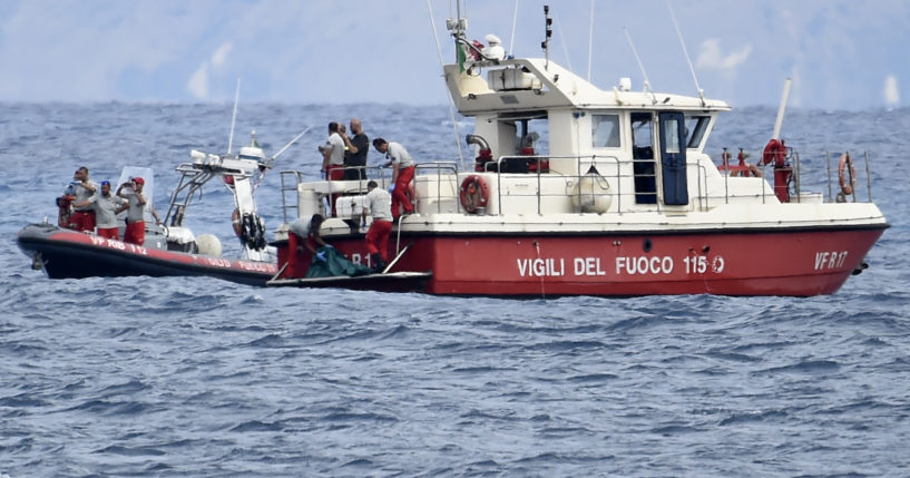 Italian Firefighter scuba divers bring ashore in a green bag the body of one of the victims of the UK flag vessel Bayesian on Wednesday. The sail yacht was hit by a violent sudden storm and sunk early Monday, while at anchor off the Sicilian village of Porticello near Palermo, in southern Italy.