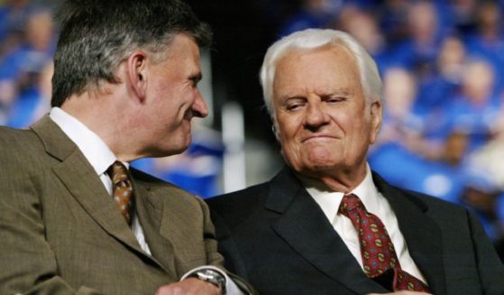 Father and son evangelists Franklin Graham and the late Billy Graham are pictured in a 2003 file photo in Oklahoma City, Oklahoma.