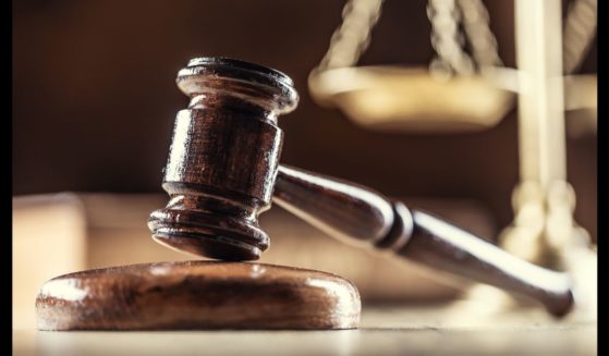 This Getty stock image shows a gavel in the foreground, and a set of scales in the background.