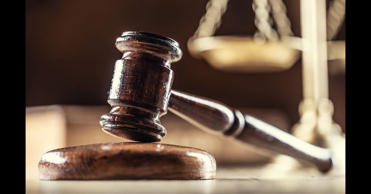 This Getty stock image shows a gavel in the foreground, and a set of scales in the background.