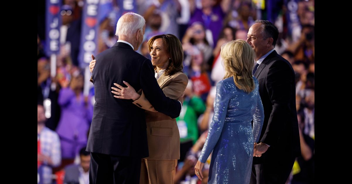 U.S. Vice President Kamala Harris greet U.S. President Joe Biden as First Lady Jill Biden and Second Gentleman Doug Emhoff look on at the end of the first day of the Democratic National Convention at the United Center on August 19, 2024 in Chicago, Illinois.