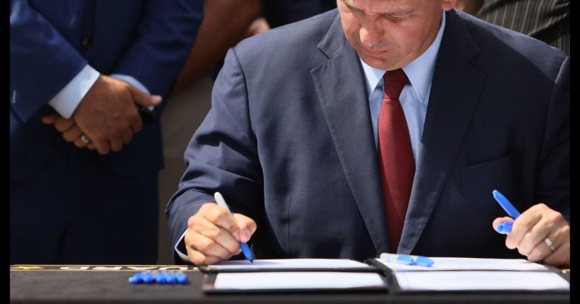 Florida Gov. Ron DeSantis signs two bills at the Florida National Guard Robert A. Ballard Armory in Miami, Florida, on June 7, 2021.