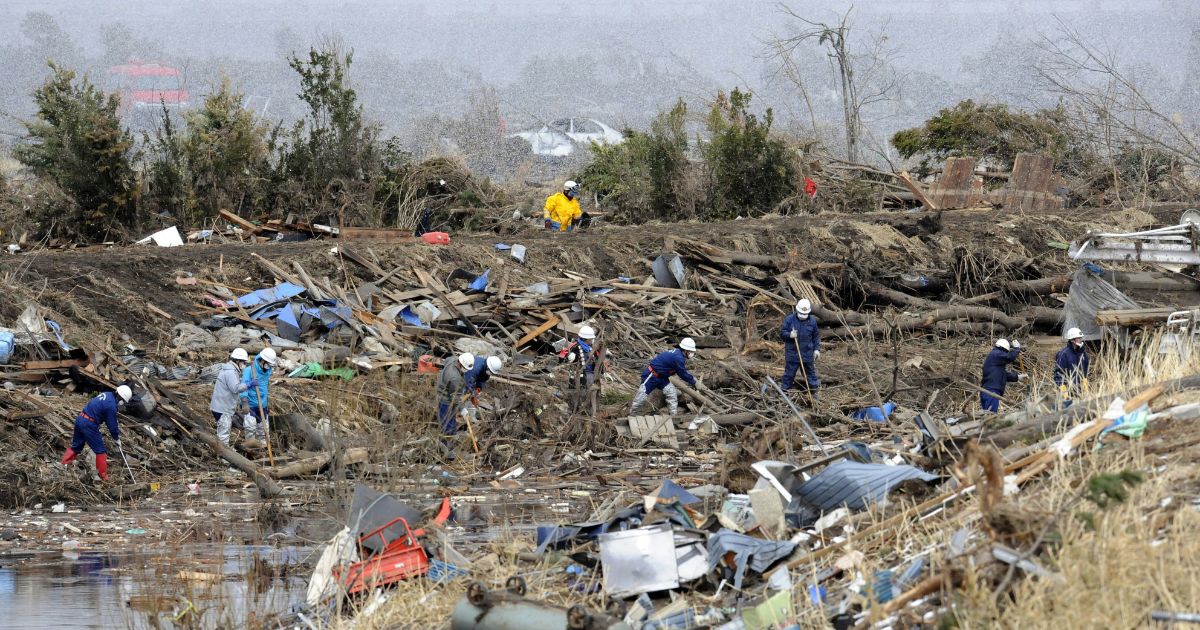 Police officers search for missing victims of the March 11 earthquake and tsunami in the village of Noda in Iwate prefecture on March 27, 2011. Dangerous levels of radiation detected in water thought to be leaking from a stricken Japanese reactor dealt a new setback on March 27 to efforts to avert a nuclear disaster.