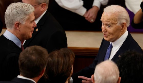 U.S. President Joe Biden (R) talks to Supreme Court Associate Justice Neil Gorsuch and other Justices as he arrives to deliver the State of the Union address during a joint meeting of Congress in the House chamber at the U.S. Capitol on March 7, 2024 in Washington, DC.