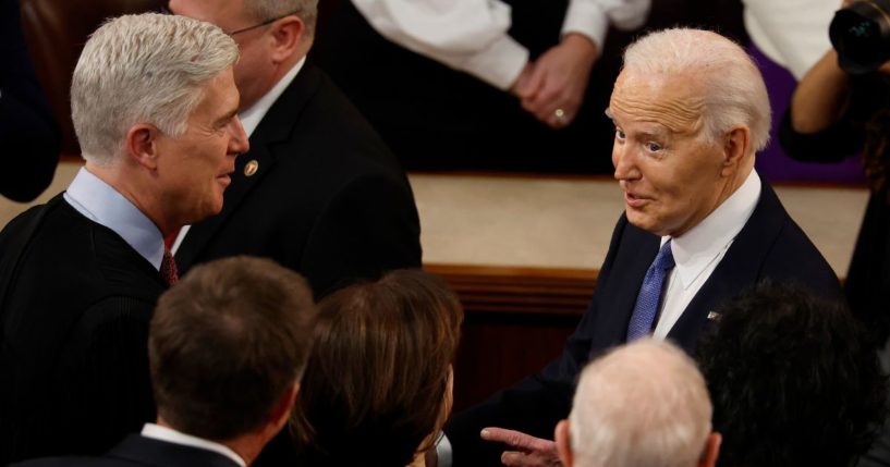 U.S. President Joe Biden (R) talks to Supreme Court Associate Justice Neil Gorsuch and other Justices as he arrives to deliver the State of the Union address during a joint meeting of Congress in the House chamber at the U.S. Capitol on March 7, 2024 in Washington, DC.