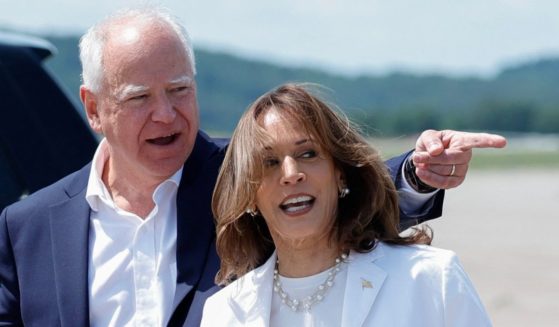 US Vice President and 2024 Democratic presidential candidate Kamala Harris (R) and her running mate Minnesota Governor Tim Walz arrive at Chippewa Valley Regional Airport in Eau Claire, Wisconsin, August 7, 2024.