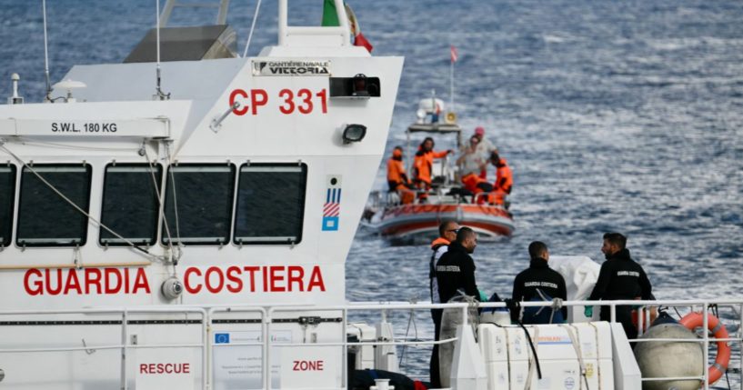 Italian Coast Guards carry a body on a rescue boat in Porticello harbor near Palermo, with a third body at the back of the boat on August 21, 2024, two days after the British-flagged luxury yacht Bayesian sank.\