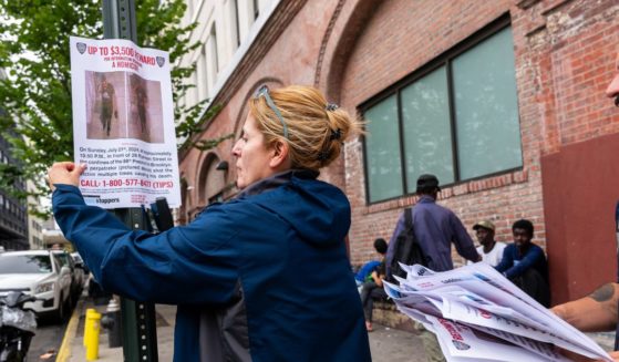 Police put up 'wanted' posters outside of two shelters in Brooklyn housing recently arrived migrant men on July 24, 2024 in New York City. Over the weekend two men were killed and a third man was hospitalized in critical condition after gunfire erupted at two separate scenes in Brooklyn near the shelters that police now believe may be related to gang violence in Venezuela.