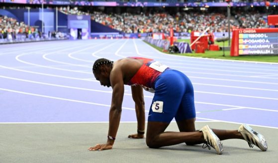 Noah Lyles collapses after earning a bronze medal in the 200-meter final at the Paris 2024 Olympic Games in Saint-Denis, France, on Thursday.