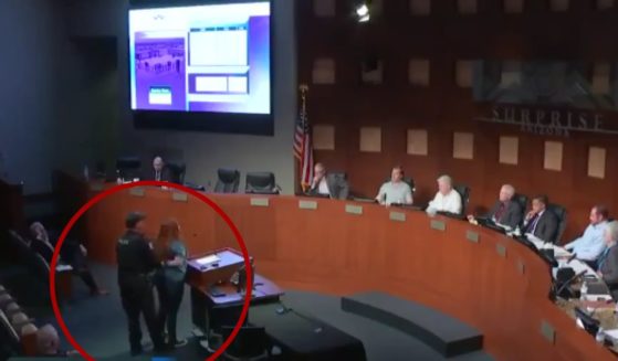 The mayor of Surprise, Arizona, Skip Hall, had Rebekah Massie, circled, arrested during a city council meeting on Aug. 20, while she was criticizing the pay of some city council officials.