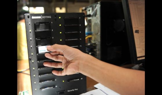 A Smartmatic worker insert a compact flash card on a computer for configuration for election automated machines at the company's warehouse in Cabuyao town, Laguna province south of Manila on May 5, 2010.