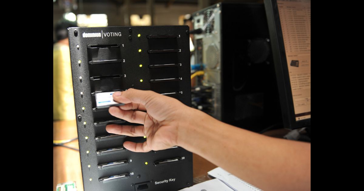 A Smartmatic worker insert a compact flash card on a computer for configuration for election automated machines at the company's warehouse in Cabuyao town, Laguna province south of Manila on May 5, 2010.