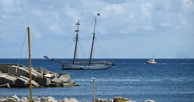 A picture shows the sailing boat named Sir Robert Baden Powell anchored in Porticello near Palermo, on August 20, 2024 a day after the British-flagged luxury yacht Bayesian sank with 22 people onboard. The Sir Robert Baden Powell ship provided immediate assistance to rescue surivors last night but six people are still missing. Specialist divers launched a fresh search for six people, including UK tech tycoon Mike Lynch and the chairman of Morgan Stanley International, missing since their yacht capsized off the Italian island of Sicily.