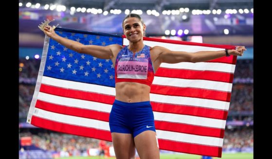 Gold medalist Sydney McLaughlin-Levrone of Team USA poses for a photo with the USA flag after the Women's 400m Hurdles Final on day thirteen of the Olympic Games Paris 2024 at Stade de France on August 8, 2024 in Paris, France.