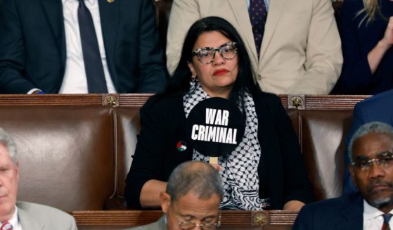 Rep. Rashida Tlaib (D-MI) holds a sign that reads "War Criminal" as Israeli Prime Minister Benjamin Netanyahu addresses a joint meeting of Congress in the chamber of the House of Representatives at the U.S. Capitol on July 24, 2024 in Washington, DC.