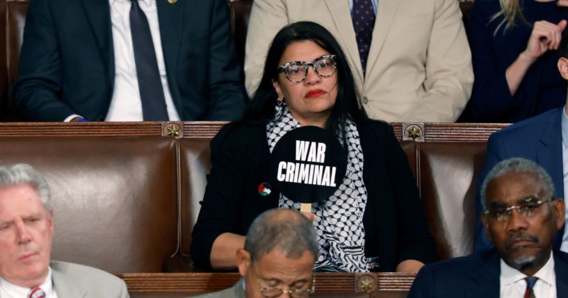 Rep. Rashida Tlaib (D-MI) holds a sign that reads "War Criminal" as Israeli Prime Minister Benjamin Netanyahu addresses a joint meeting of Congress in the chamber of the House of Representatives at the U.S. Capitol on July 24, 2024 in Washington, DC.