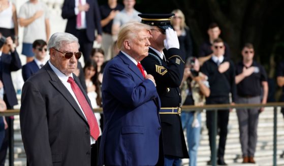 Republican presidential nominee, former U.S. President Donald Trump stands alongside Bill Barnett (L), who's grandson Staff Sgt Darin Taylor Hoover died in Abbey Gate Bombing, during a wreath laying ceremony at the Tomb of the Unknown Soldier at Arlington National Cemetery on August 26, 2024 in Arlington, Virginia.