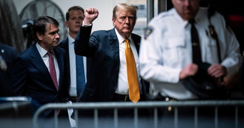 Former U.S. President Donald Trump raises his fist as he arrives for his criminal trial at Manhattan Criminal Court on May 29, 2024 in New York City.