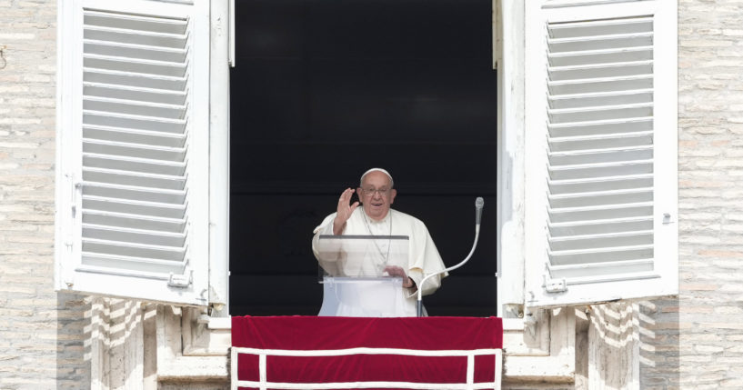 Pope Francis waves from the window of his studio overlooking St.Peter's Square during the Angelus noon prayer at the Vatican on Sunday.