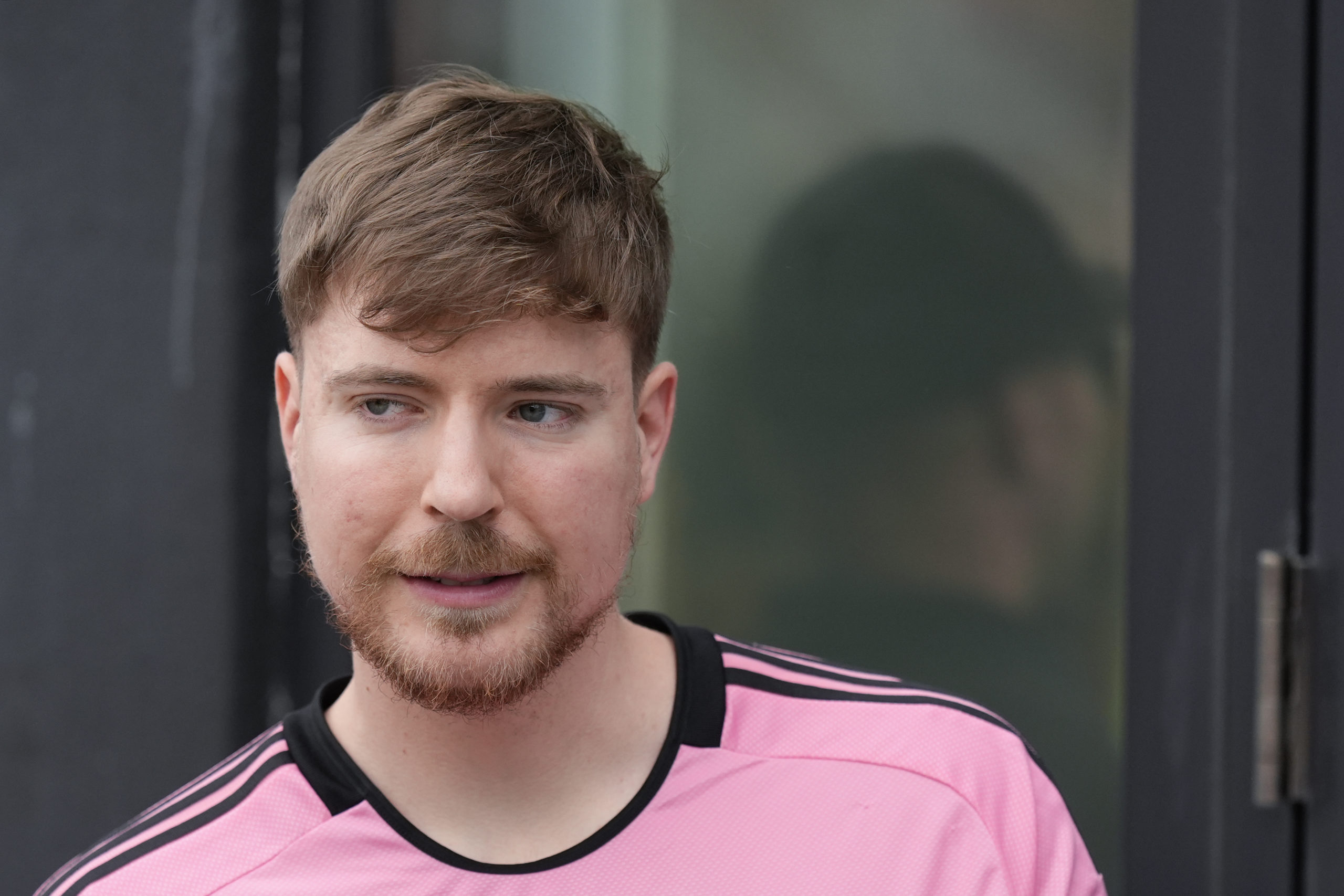 Jimmy Donaldson, the popular YouTube video maker who goes by MrBeast, wears a Lionel Messi jersey as he stands in a sideline box at the start of an MLS soccer match between Inter Miami and CF Montreal Sunday, March 10, 2024, in Fort Lauderdale, Florida.