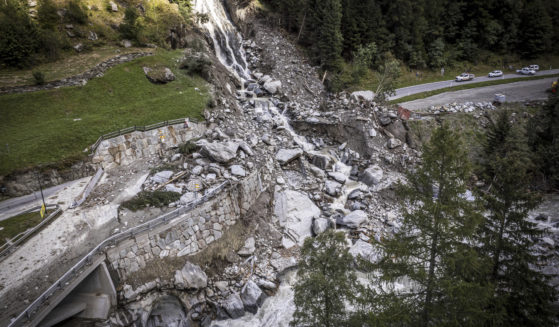 A road is blocked in Eisten, Switzerland on Friday after a landslide following severe weather.