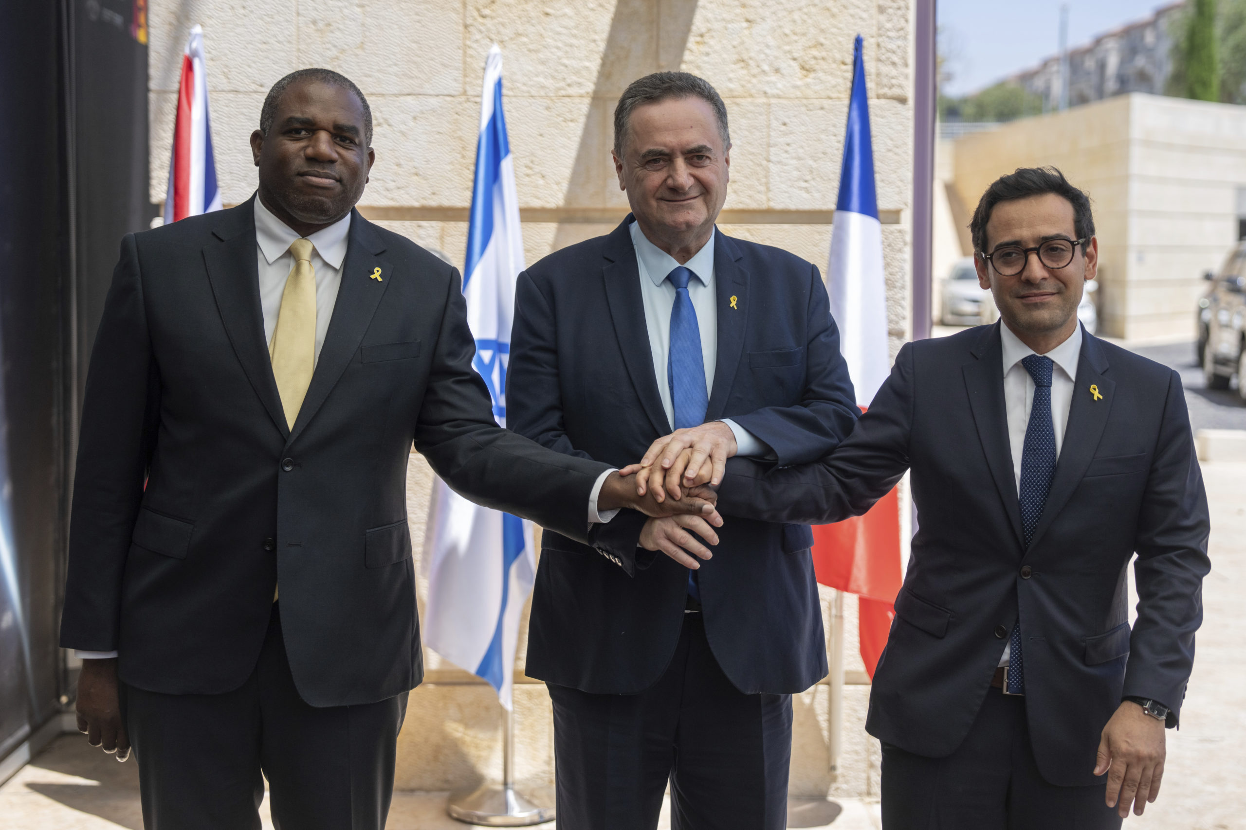 Britain's Foreign Secretary David Lammy, left, and French Foreign Minister Stéphane Séjourné, right, are welcomed by Israeli Minister of Foreign Affairs Israel Katz, at their meeting in Jerusalem in Aug. 16.