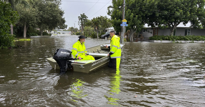 Rescue crews assist residents after conducting door-to-door wellness checks in coastal areas that were flooded by Hurricane Helene Friday in Venice, Florida .