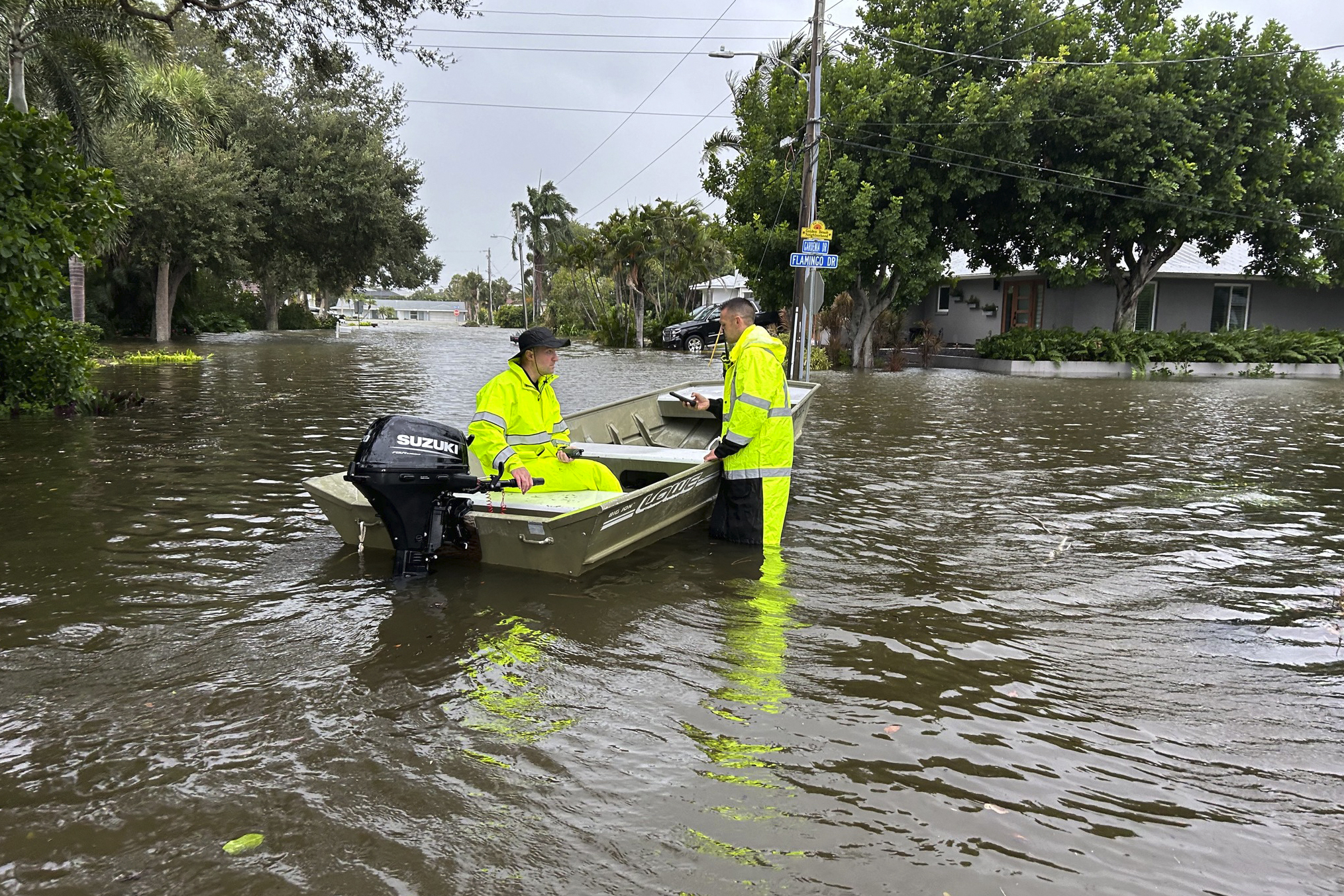 Rescue crews assist residents after conducting door-to-door wellness checks in coastal areas that were flooded by Hurricane Helene Friday in Venice, Florida .