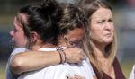 People embrace at a makeshift memorial after a shooting Wednesday at Apalachee High School on Thursday in Winder, Georgia.