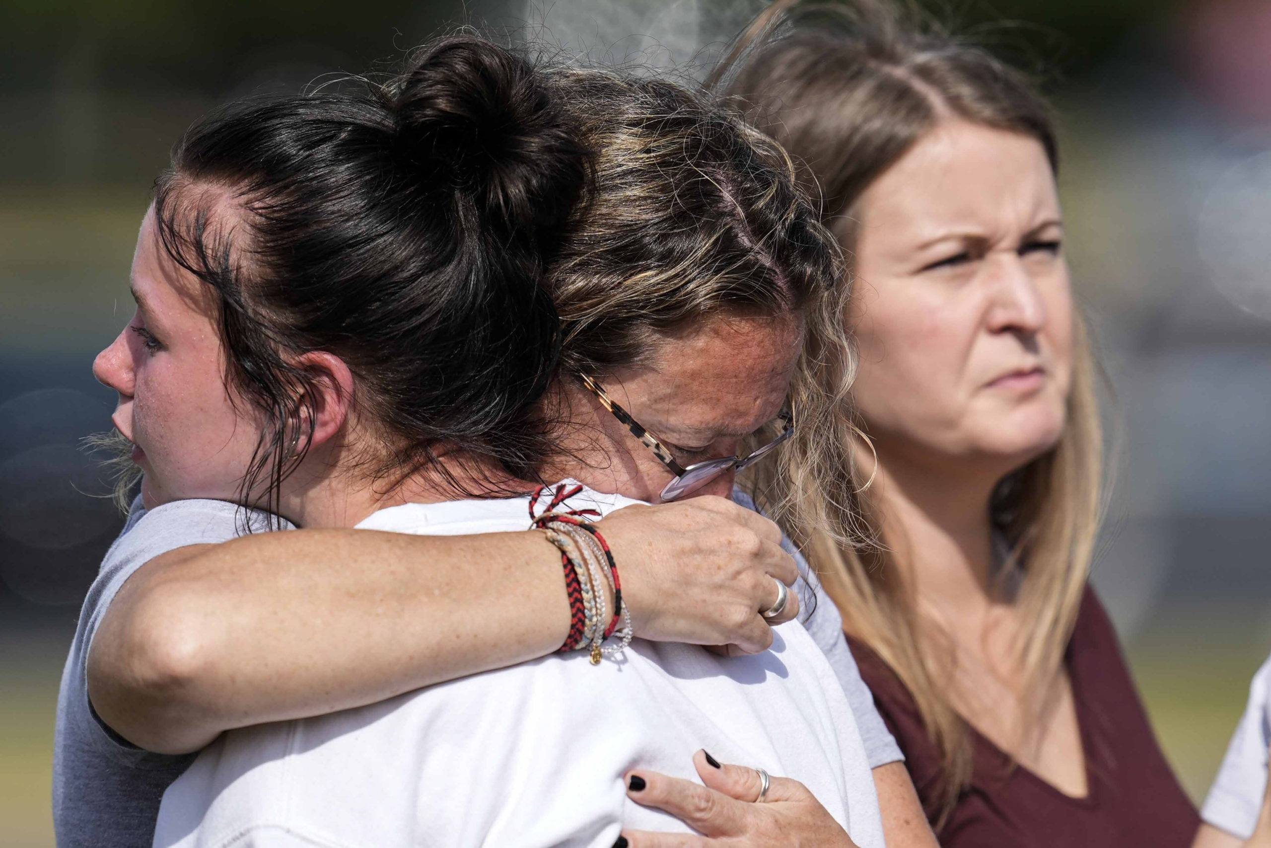 People embrace at a makeshift memorial after a shooting Wednesday at Apalachee High School on Thursday in Winder, Georgia.