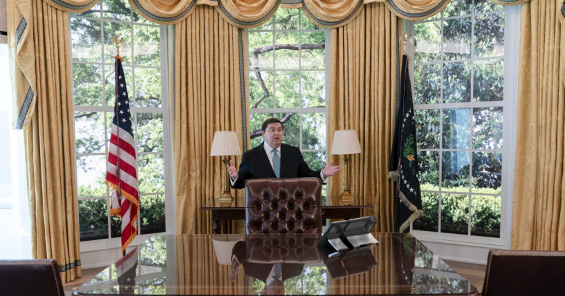 White House Historical Association President Stewart McLaurin shows members of the media a replica of the Oval Office at The People's House exhibit in Washington, D.C.