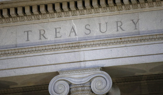 This June 6, 2019, file photo shows the U.S. Treasury Department building at dusk in Washington.