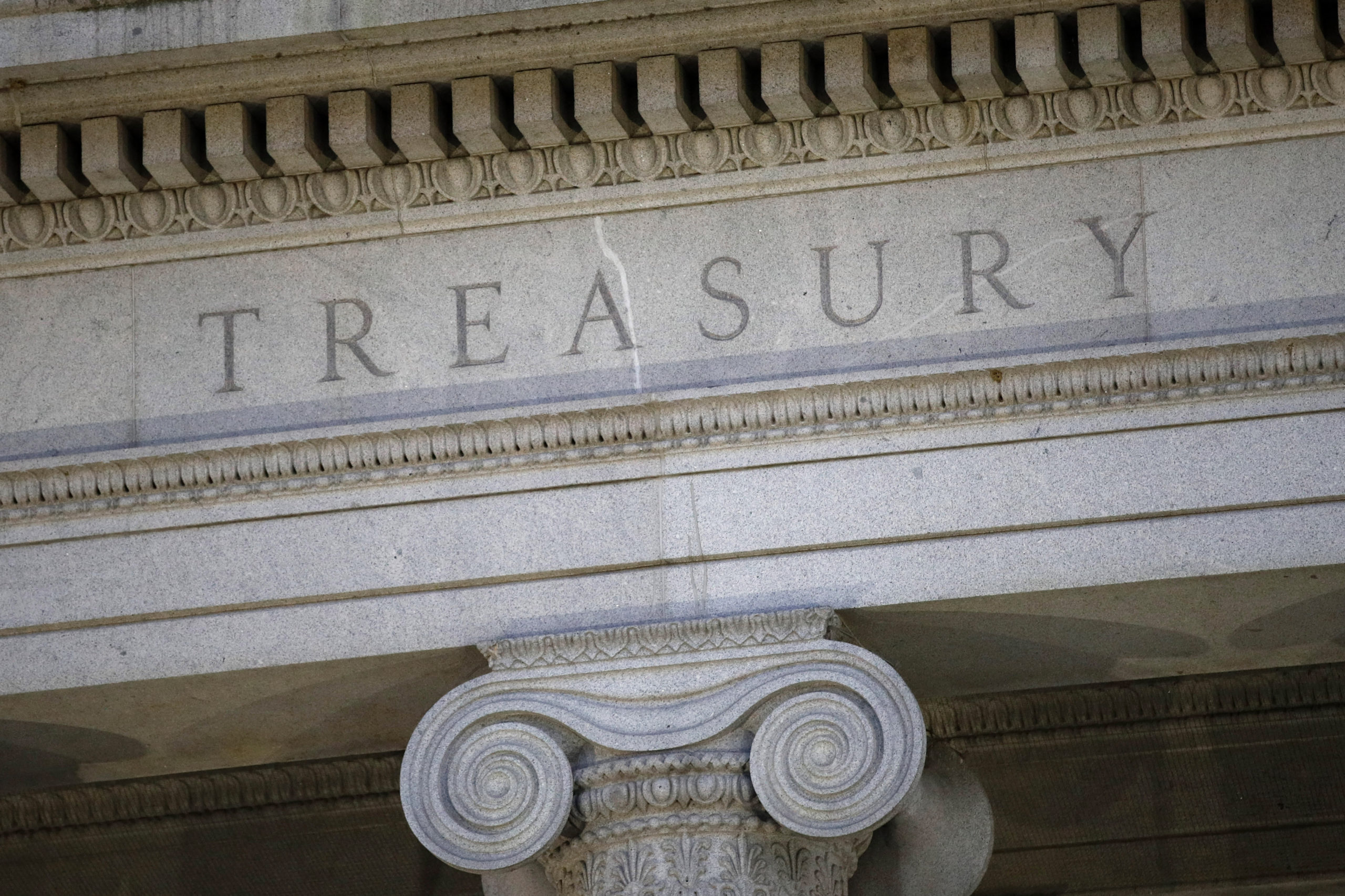 This June 6, 2019, file photo shows the U.S. Treasury Department building at dusk in Washington.