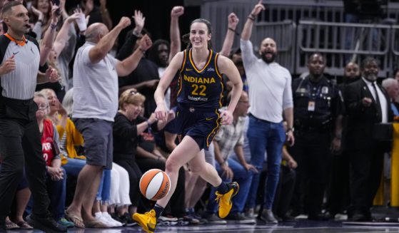 Indiana Fever guard Caitlin Clark smiles after nabbing her tenth rebound in the closing seconds of a game against the Los Angeles Sparks in Indianapolis, Indiana, on Wednesday.