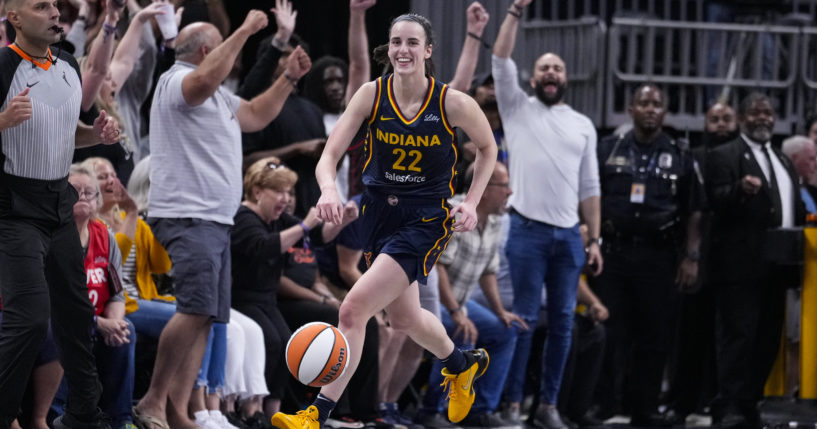 Indiana Fever guard Caitlin Clark smiles after nabbing her tenth rebound in the closing seconds of a game against the Los Angeles Sparks in Indianapolis, Indiana, on Wednesday.