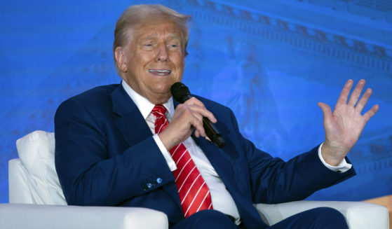 Republican presidential nominee former President Donald Trump speaks with Moms for Liberty co-founder Tiffany Justice during an event at the group's annual convention in Washington on Friday.