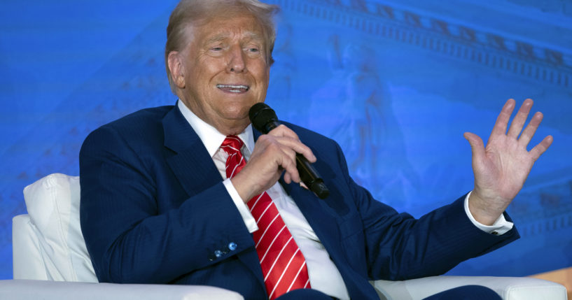 Republican presidential nominee former President Donald Trump speaks with Moms for Liberty co-founder Tiffany Justice during an event at the group's annual convention in Washington on Friday.