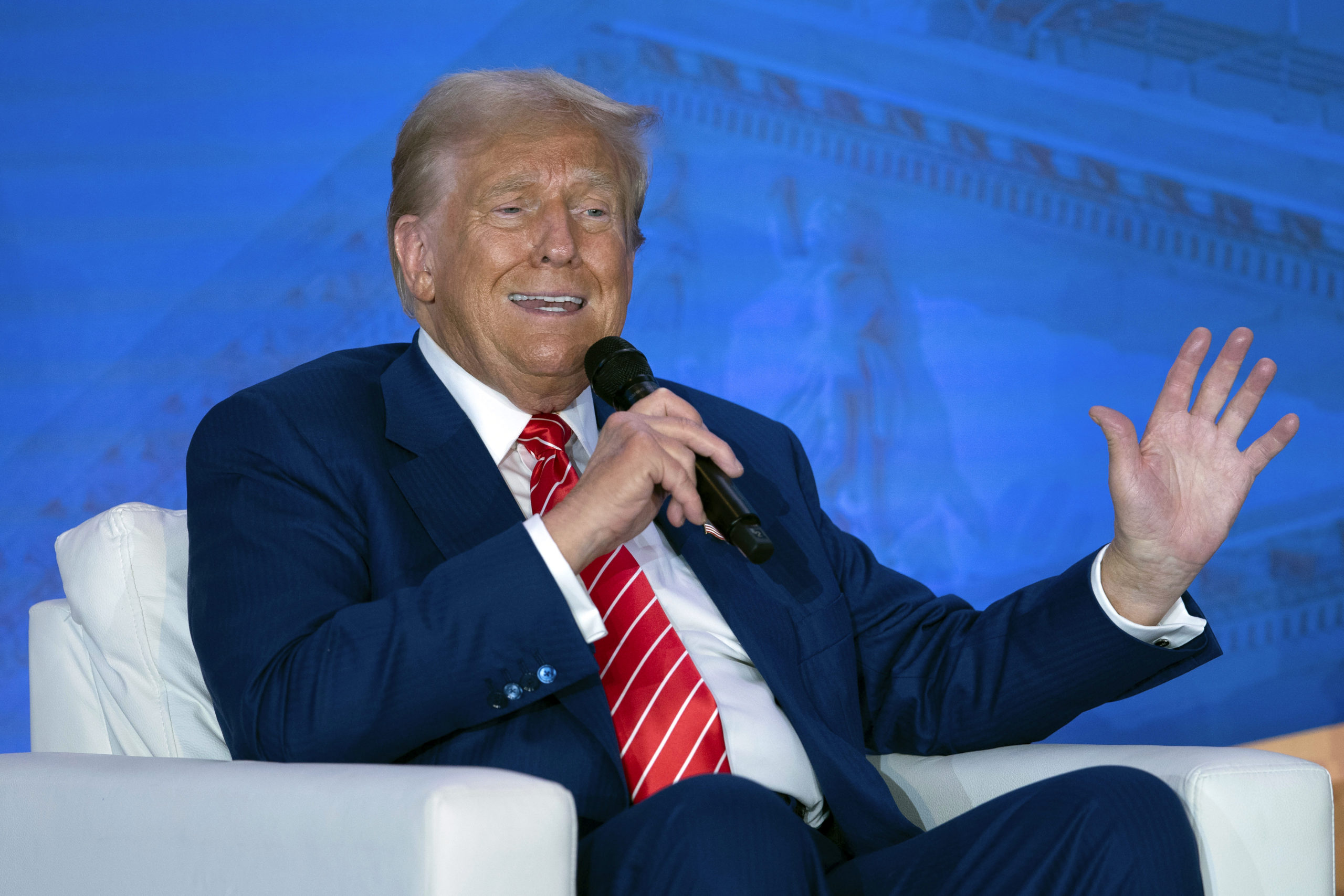 Republican presidential nominee former President Donald Trump speaks with Moms for Liberty co-founder Tiffany Justice during an event at the group's annual convention in Washington on Friday.