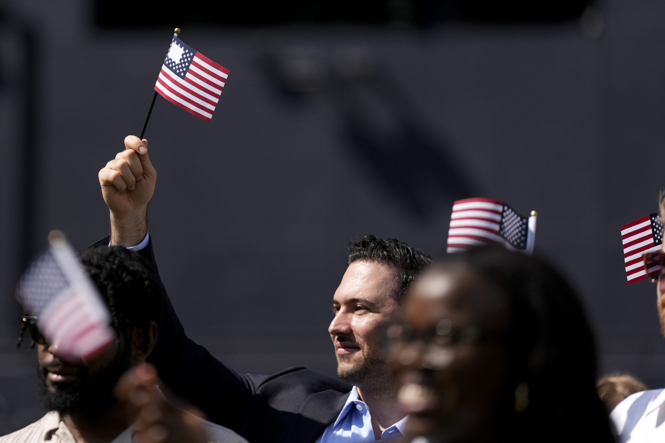 A man, part of a group of 50 new United States citizens from 25 different countries, takes part in a naturalization ceremony before the San Diego Padres host the Minnesota Twins in a baseball game in San Diego on Aug. 21.