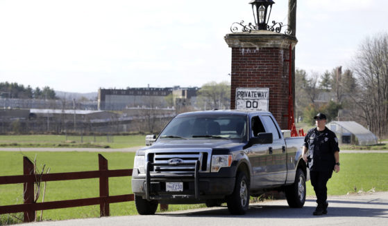 A police officer guards an entrance to the Souza-Baranowski Correctional Center in Shirley, Massachusetts, on Wednesday.