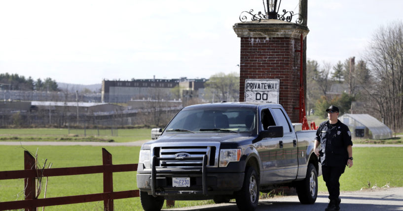 A police officer guards an entrance to the Souza-Baranowski Correctional Center in Shirley, Massachusetts, on Wednesday.